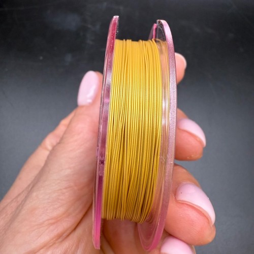 Тросик ювелирный SakuLux (Япония), 7 стальных струн, с силиконовым покрытием, цвет золото, толщина 0,45 мм, 10 м в катушке